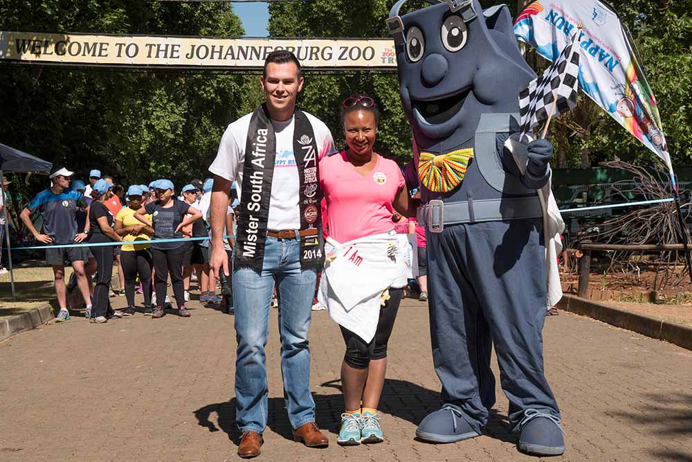 Mister South Africa 2014 and the event mascot posing with a participant at Johannesburg Zoo