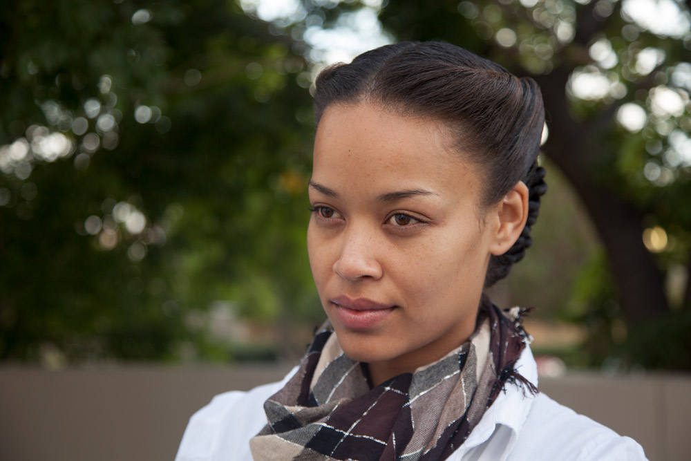 Natural light fashion portrait of model with braided hair and contemporary styling outdoors Johannesburg