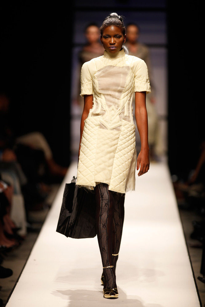 Model wearing structured white quilted design with architectural details on SA Fashion Week runway Johannesburg