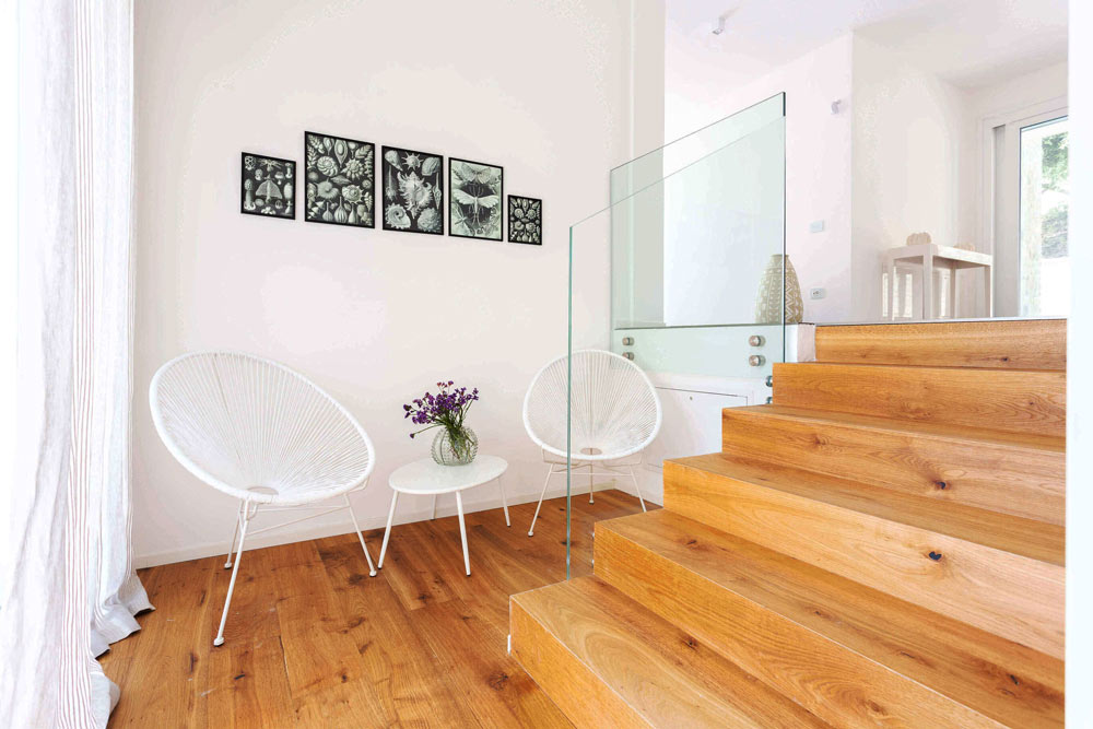 Minimalist hotel interior seating area with wooden staircase at boutique accommodation in Sandton