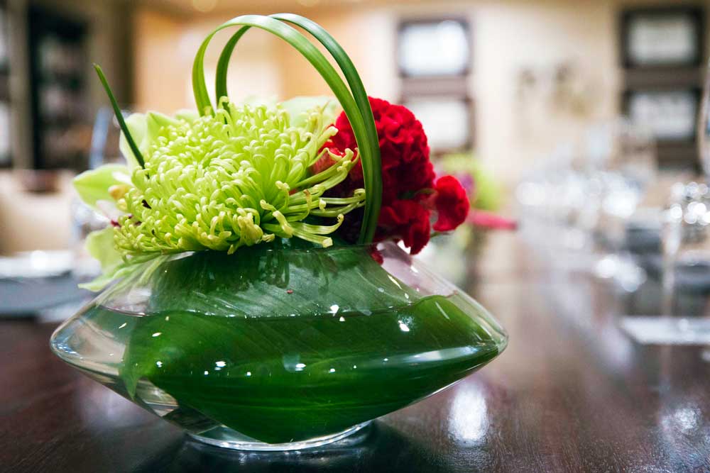 Hotel dining floral centrepiece detail photography for luxury accommodation marketing Johannesburg